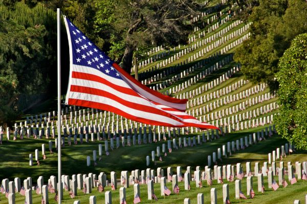 American flag flying over Veteran's graves